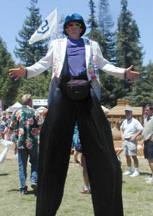 Stilt walker with multicolored
    sunglasses